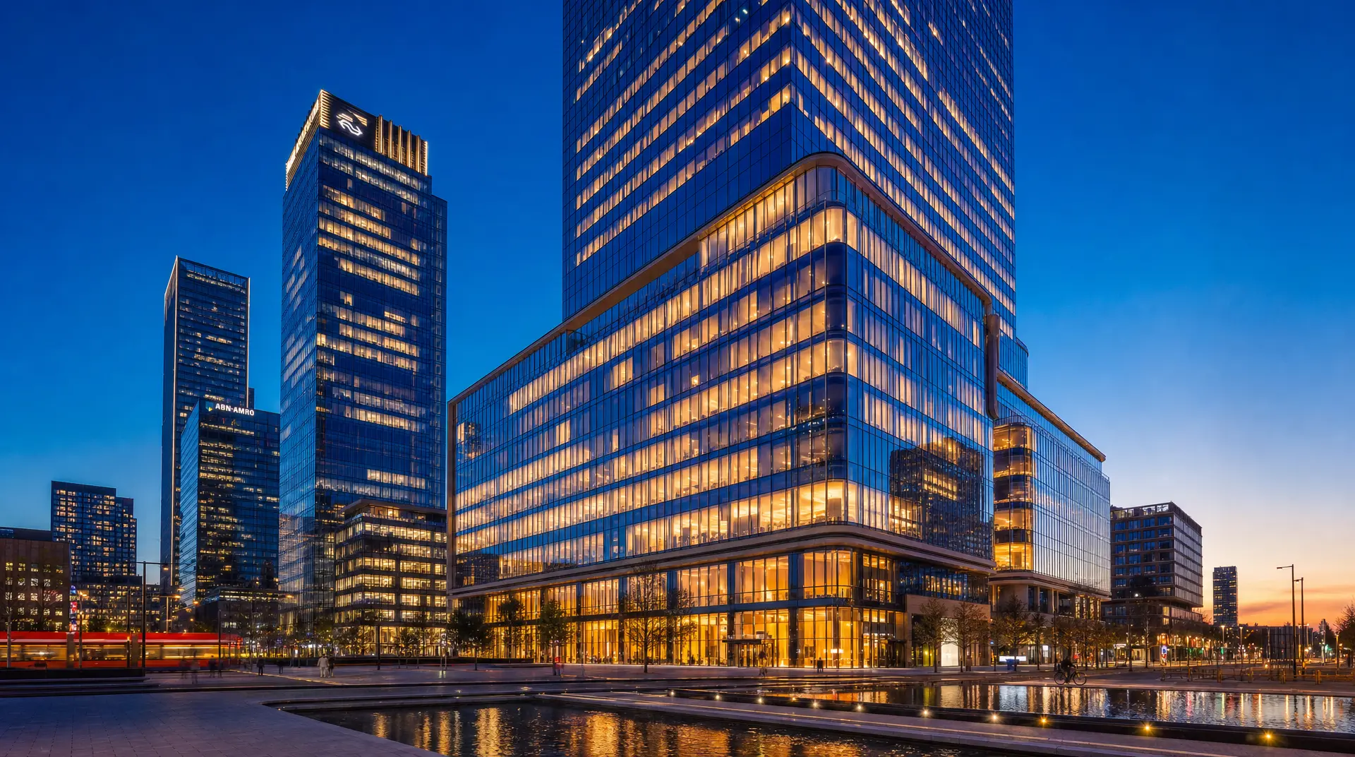 Glass office towers glow at dusk, evoking corporate compliance oversight for global entities.